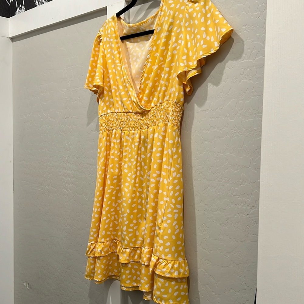 Yellow print dress.  Large size but runs small.  Cute with ruffle cap sleeves.